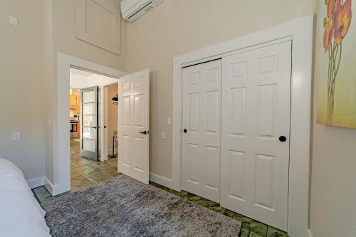 a hallway with white doors and a rug at The Pool House in Ferndale