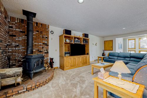 a living room with a blue couch and a fireplace at Nature's Getaway in Bartlett