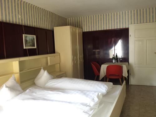 a hotel room with two beds and a table with a table at Hotel zur guten Quelle in Selters