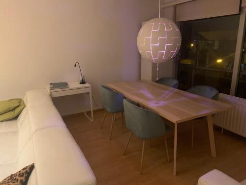 a living room with a wooden table and a couch at nice and cosy apartment in Edegem