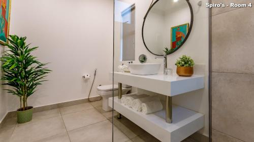 a bathroom with a sink and a mirror at Christies at 32 on Russell in Nelspruit
