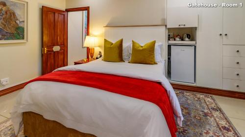 a bedroom with a large bed with yellow pillows at Christies at 32 on Russell in Nelspruit