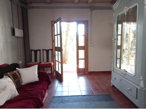 a living room with a couch and a open door at La Bodega de Villa Bella in Espartinas