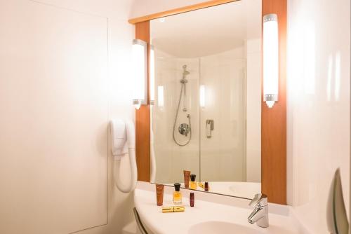 a bathroom with a sink and a shower at ibis Esch Belval in Esch-sur-Alzette