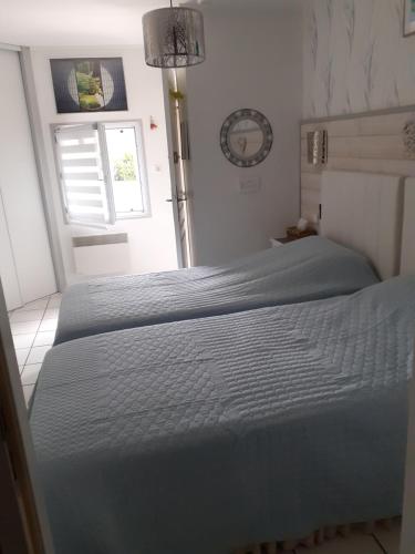 a large bed in a bedroom with a window at La Sylreine in Crottet