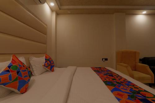a hotel room with a bed and a chair at Shri Tirupati Residency in Nilmatha