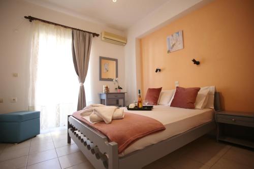 a bedroom with a large bed and a window at AnKo & AnKo 1 in Nydri