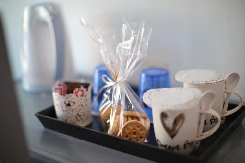 a tray with cups and other items on a table at AnKo & AnKo 1 in Nydri
