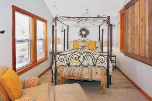 a bedroom with a bed with a wrought iron frame at Ah! This is the life! in Wimberley