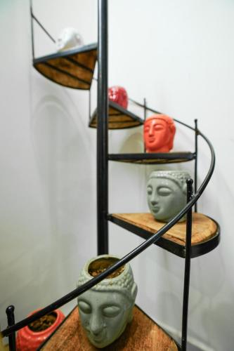 a shelf with three head heads on it at Lime Tree Service Apartment - Near Artemis Hospital ,Gurgaon in Gurgaon