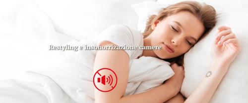 a woman laying on a bed with two tattoos on her arm at Hotel della Vittoria in Ancona