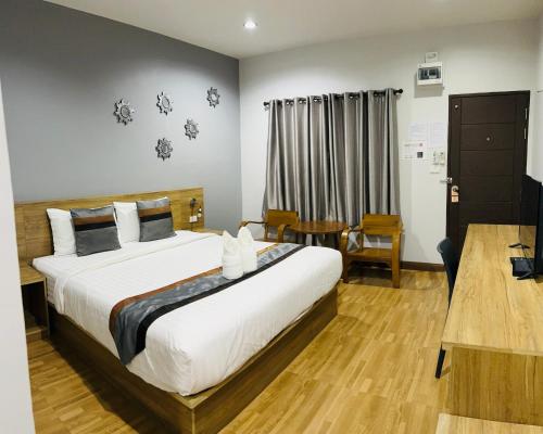 Una cama o camas en una habitación de ช้างเผือกเกสต์เฮ้าส์ Changphueak Guesthouse