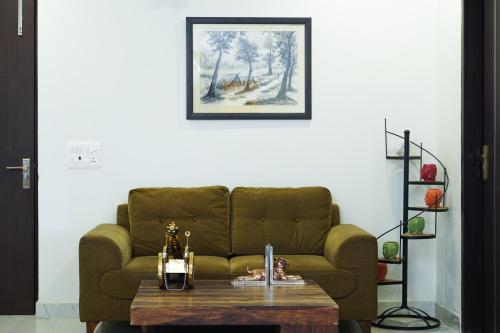 a living room with a couch and a table at Lime Tree Service Apartment - Near Artemis Hospital ,Gurgaon in Gurgaon
