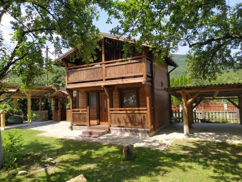 a log house with a porch and a yard at Family Plai in Yaremche