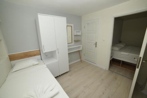 a small room with two beds and a small bedroom at Limonata Hotel Assos in Behramkale