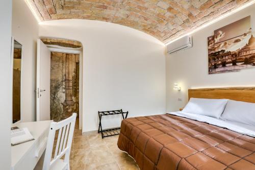 a bedroom with a bed and a brick ceiling at Romarina in Rome
