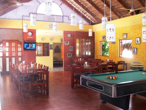 a restaurant with a pool table in the middle of a room at Hotel Voramar in Sosúa