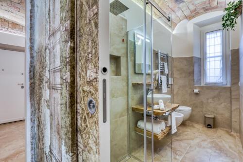 a bathroom with a glass shower and a sink at Romarina in Rome