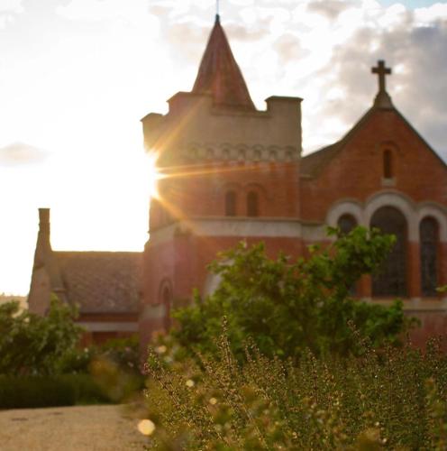 a church with the sun shining on a building at A Tassie Church in Kempton