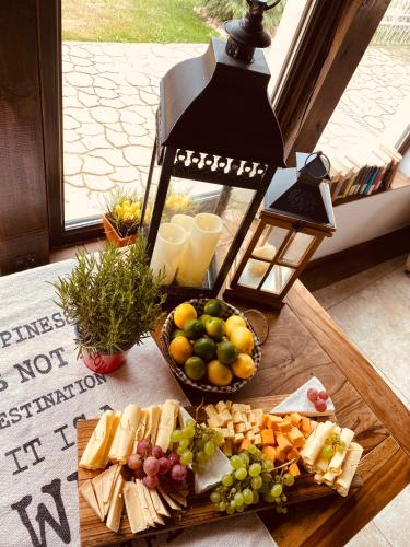a table topped with a plate of cheese and fruit at Casa Pisica Noastra in Breaza