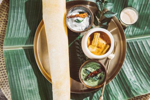 a plate with two dishes of food on a table at Six Senses Fort Barwara Sawai Madhopur in Sawāi Mādhopur