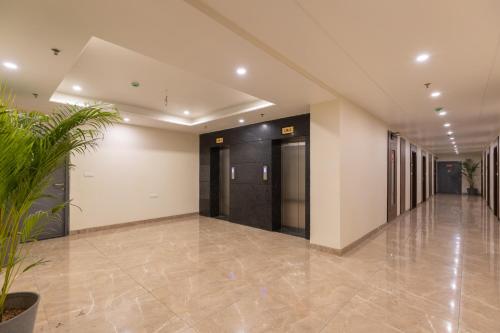 an empty hallway in a building with plants at HOTEL HIGHWAY KING Bilaspur in Manesar
