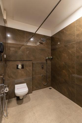 a bathroom with a toilet and a shower at HOTEL HIGHWAY KING Bilaspur in Manesar