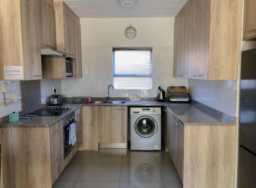 a kitchen with a washer and a dishwasher at Alendo Apartments in Johannesburg