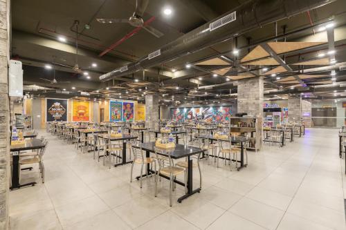 a dining room with tables and chairs in it at HOTEL HIGHWAY KING Bilaspur in Manesar