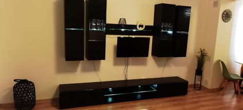 a living room with a black table and black cabinets at Focus Lux in Miercurea-Ciuc