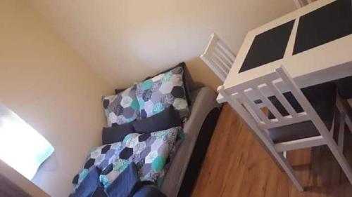 a small room with a bunk bed and a ladder at Mała Chatka domek Zator Oświęcim in Polanka Wielka