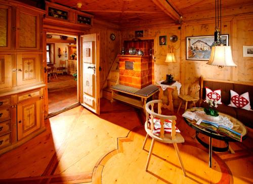 a living room with a table and a dining room at Schlosshotel Chastè in Tarasp