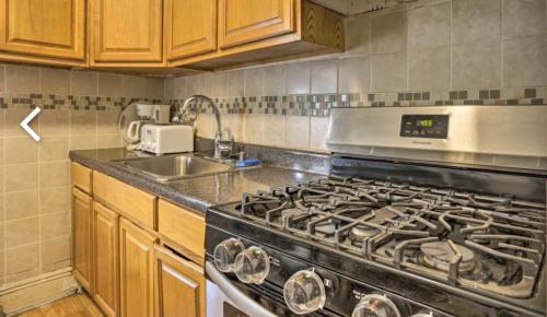 a kitchen with a stove and a sink at 1 COZY APt IN WEST NY, NEW JERSEY, at 2 bloks from bus stop-15 minutes 2NY 7MINUTES VIA NYWATERWAY FERRY-BETTER CAN'T BE!! in West New York