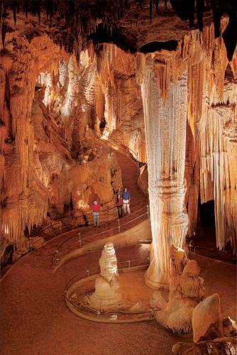 two people standing in a cave with ice formations at Luray Caverns Motels in Luray