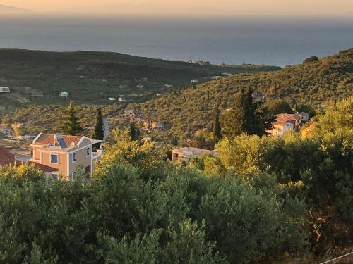 a town on a hill with the ocean in the background at Villa Thea - The View 2nd floor in Áno Yerakaríon