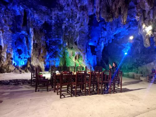 a person sitting at a table in a cave at Yen Nhi Homestay Ban Gioc in Cao Bằng