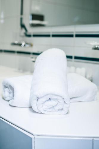 a stack of towels sitting on a bathroom counter at Hotel Walserwirt in Wals