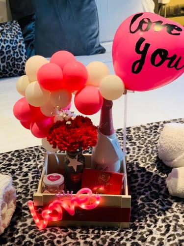 a box with a bunch of balloons and a bouquet of flowers at DAOS Suites & Terrace Marbella in Marbella