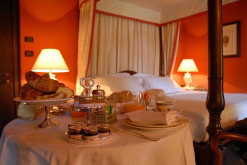 a table with food and bread on a bed at Hotel Torre di San Martino in Gazzola Di Rivalta