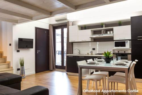 kuchnia i jadalnia ze stołem i krzesłami w obiekcie Ottomood House Catania w Katanii