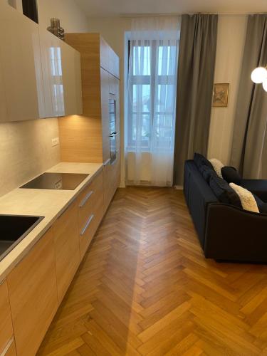 a kitchen with a black couch in a room at Apartmány Marienhof in Znojmo