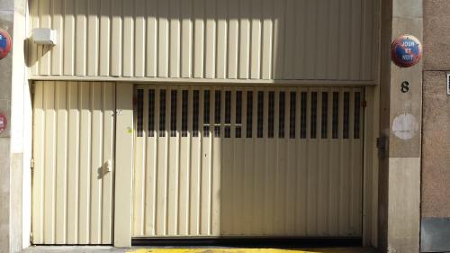 ajar door of a building with a gate at ATN Hôtel in Paris