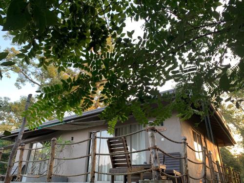 a house with a rocking chair in front of it at Kele Yala in Yala