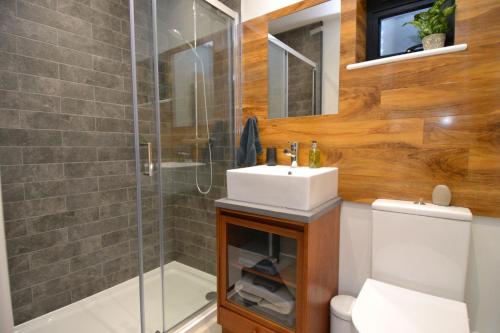 a bathroom with a sink and a shower at The Burrow at Tankerton in Whitstable