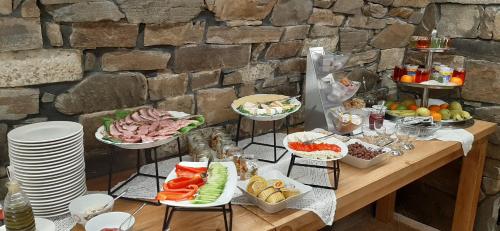 a table with many plates of food on it at Apartamenty i pokoje Pod Limbami - sauna, tężnia in Bukowina Tatrzańska