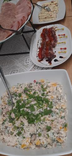 three plates of food on a table with rice and meat at Apartamenty i pokoje Pod Limbami - sauna, tężnia in Bukowina Tatrzańska
