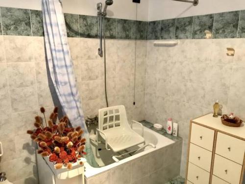 a bathroom with a bath tub with a shower and a sink at La Cà Granda 
