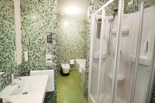 a bathroom with a sink and a shower at Regiohotel Manfredi in Manfredonia