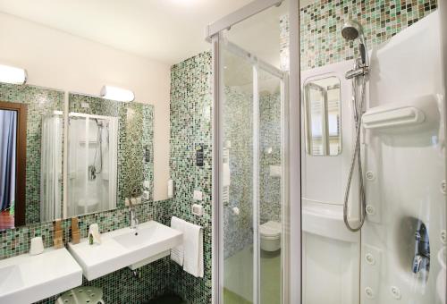 a bathroom with a shower and a sink and a toilet at Regiohotel Manfredi in Manfredonia