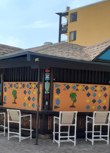 a group of chairs sitting outside of a building at Daytona Beach Hawaiian Inn in Daytona Beach